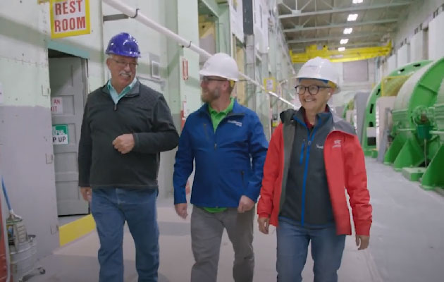Hydro employees walk through Madison Dam.